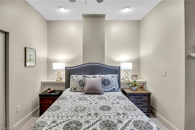 carpeted bedroom featuring baseboards and a ceiling fan