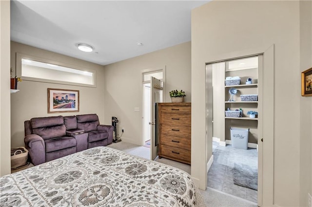 bedroom featuring light carpet and baseboards