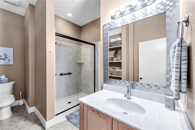 full bathroom featuring toilet, vanity, baseboards, tile patterned floors, and a stall shower