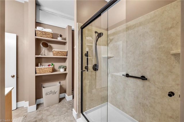 full bath featuring tile patterned flooring, a shower stall, and baseboards