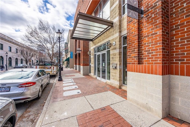 view of exterior entry with brick siding