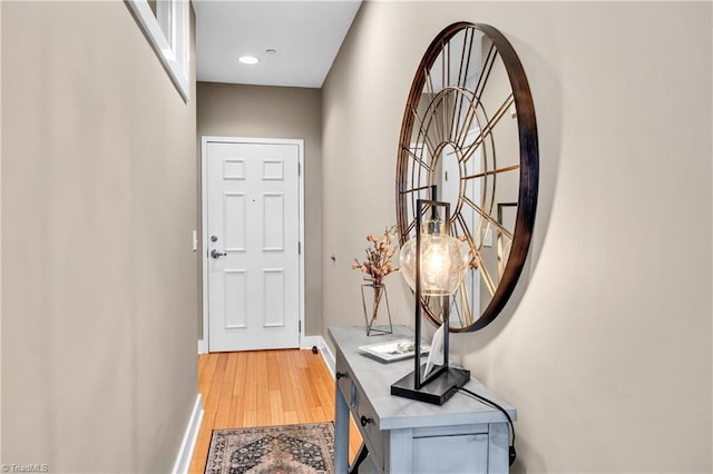 entryway with light wood finished floors and baseboards