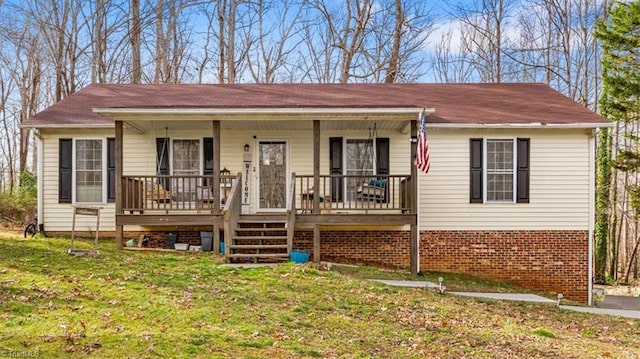 view of front of property with a front lawn, a porch, and brick siding