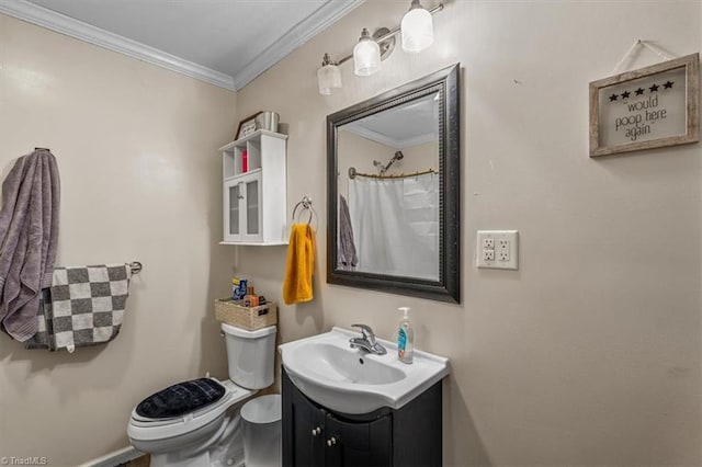 bathroom with ornamental molding, vanity, and toilet