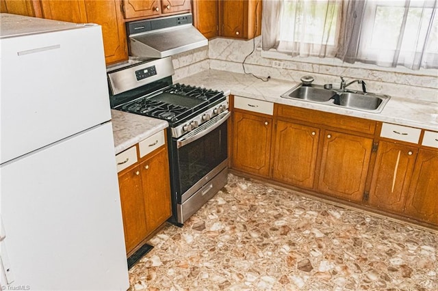 319 Cherry St, Eden, NC 27288 - kitchen featuring light countertops, a sink, freestanding refrigerator, under cabinet range hood, and gas stove