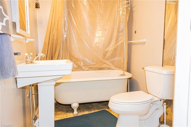 319 Cherry St, Eden, NC 27288 - bathroom featuring a tub, toilet, and tile patterned flooring