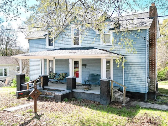 319 Cherry St, Eden, NC 27288 - view of front of property with covered porch, a shingled roof, and a chimney