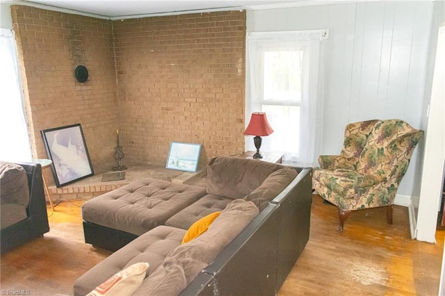 319 Cherry St, Eden, NC 27288 - living area featuring wood finished floors and brick wall