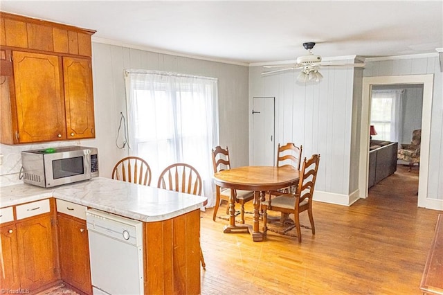 319 Cherry St, Eden, NC 27288 - kitchen with light countertops, stainless steel microwave, light wood finished floors, dishwasher, and a peninsula