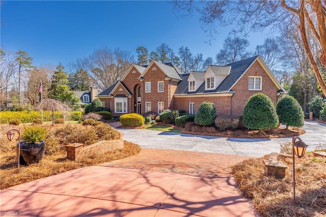 view of front facade featuring driveway and brick siding