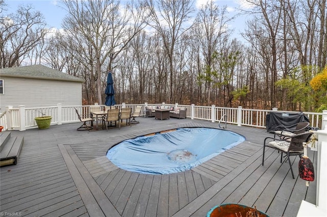 view of swimming pool featuring an outdoor living space, grilling area, and a wooden deck