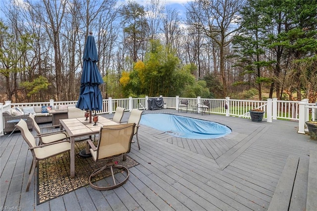 wooden deck with a covered pool