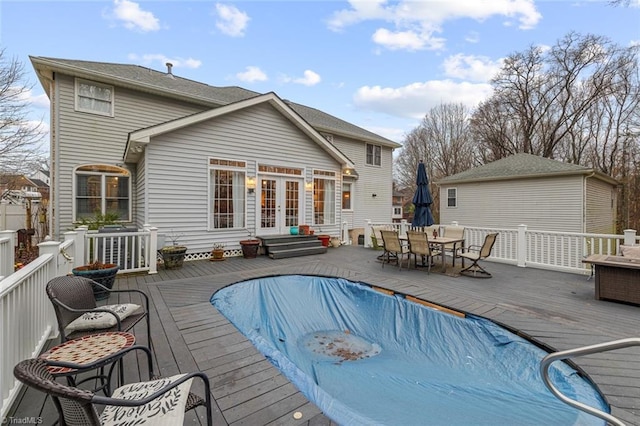 back of property featuring a swimming pool side deck