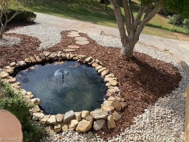 exterior space with a garden pond