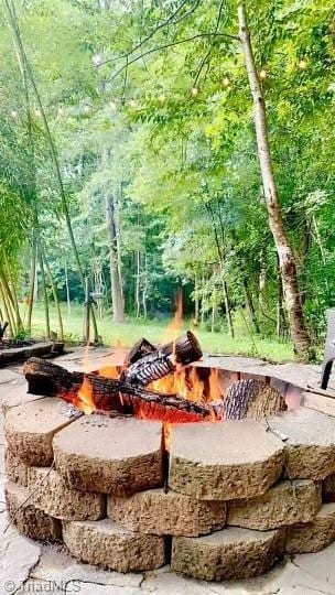 view of community featuring an outdoor fire pit