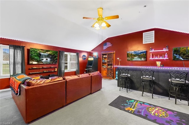 home theater room featuring vaulted ceiling, ceiling fan, and indoor bar