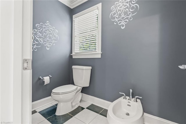 bathroom featuring toilet, tile patterned floors, a bidet, and crown molding