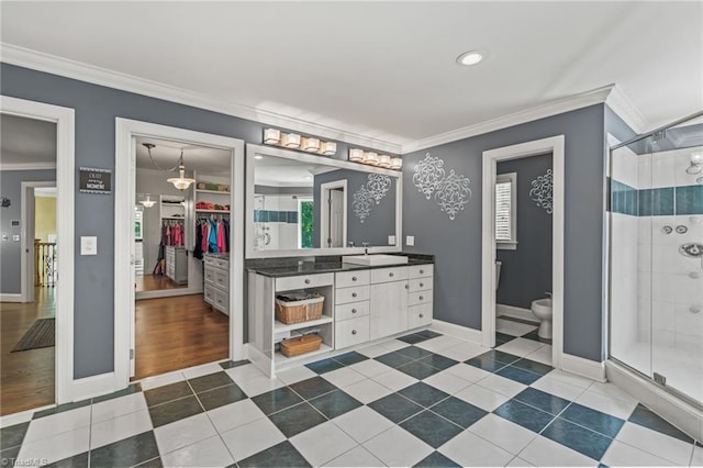 bathroom with a wealth of natural light, tile patterned flooring, vanity, and a shower with door