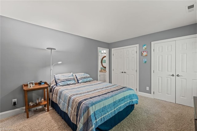 bedroom with carpet and multiple closets