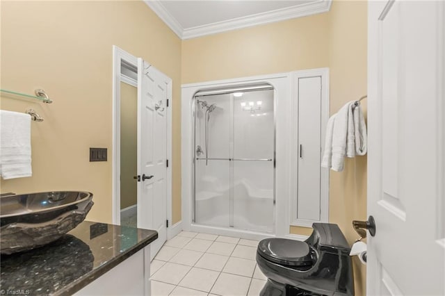 bathroom featuring tile patterned floors, a shower with door, and crown molding