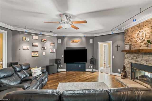 living room featuring hardwood / wood-style flooring, ornamental molding, and a fireplace