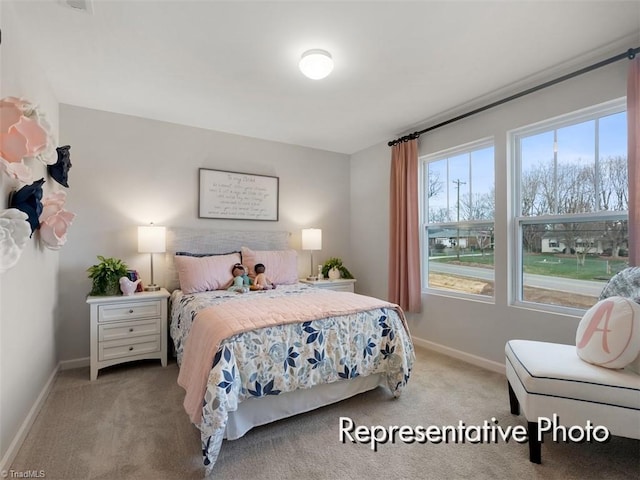 bedroom featuring carpet flooring and baseboards