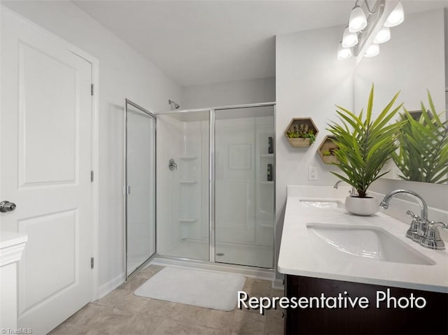 full bath with a sink, a stall shower, and double vanity