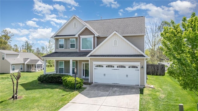 craftsman-style home featuring board and batten siding, concrete driveway, a garage, and a front lawn