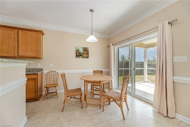 dining area featuring baseboards and crown molding