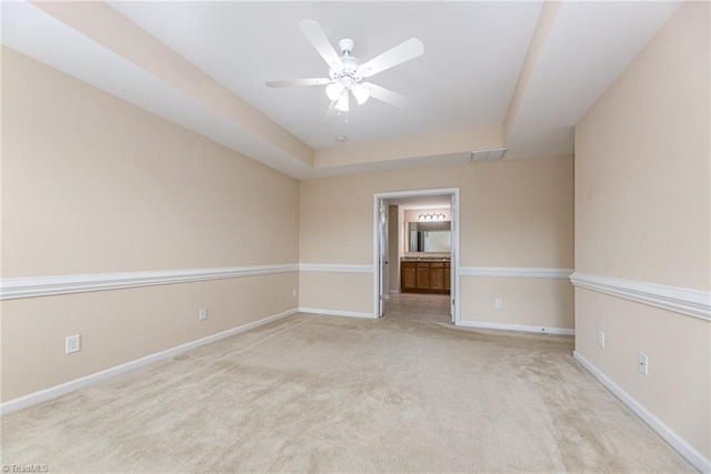 empty room featuring ceiling fan, baseboards, visible vents, and carpet floors