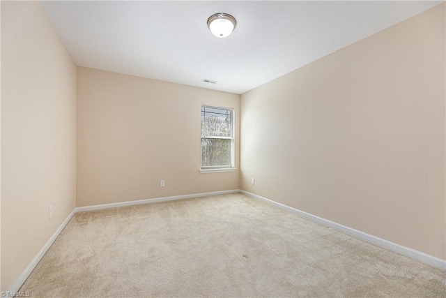 empty room with visible vents, baseboards, and carpet floors