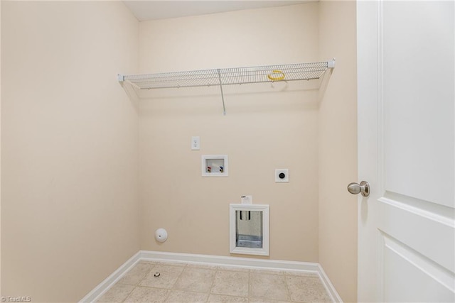 laundry area with laundry area, hookup for a washing machine, electric dryer hookup, light tile patterned flooring, and baseboards