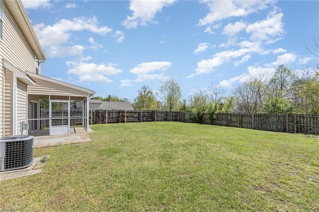 view of yard featuring central air condition unit, a fenced backyard, and a sunroom