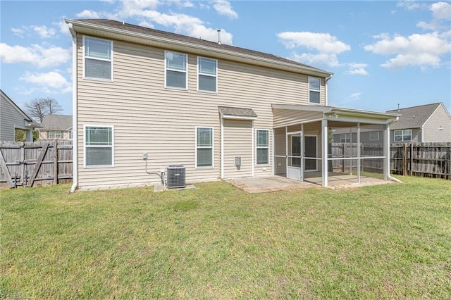 back of property with a yard, a fenced backyard, cooling unit, and a sunroom