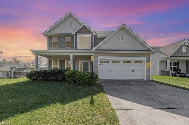 view of front of home featuring a yard, concrete driveway, a garage, and covered porch