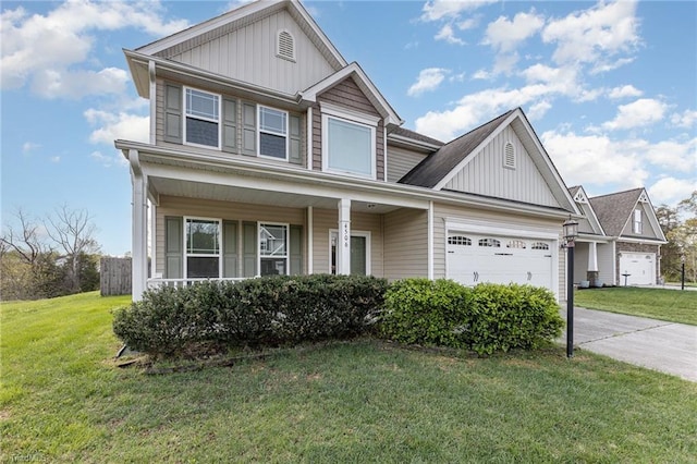 traditional-style home with a front yard, an attached garage, covered porch, board and batten siding, and concrete driveway