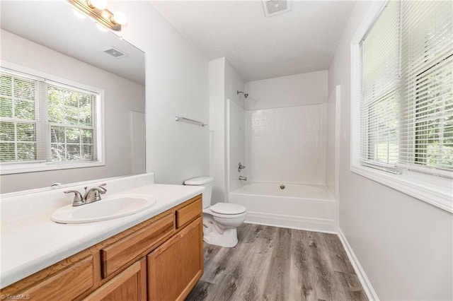 5207 Highland Oak Ct, Greensboro, NC 27410 - bathroom with vanity, wood finished floors, tub / shower combination, and healthy amount of natural light