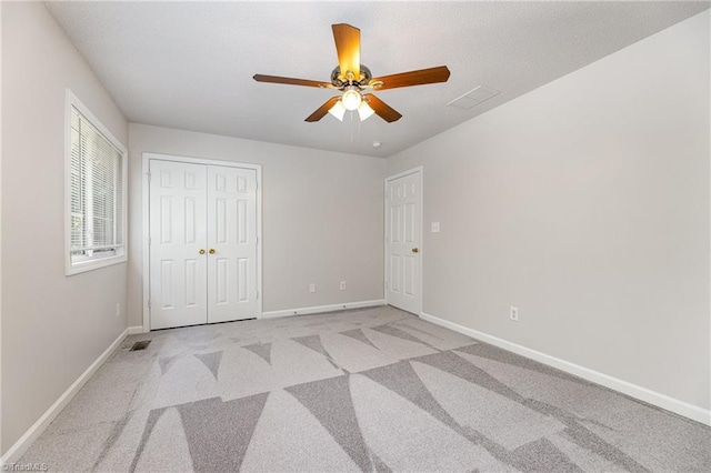 5207 Highland Oak Ct, Greensboro, NC 27410 - unfurnished bedroom featuring light colored carpet, a closet, and ceiling fan