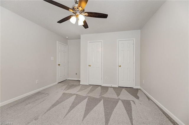 5207 Highland Oak Ct, Greensboro, NC 27410 - unfurnished bedroom with carpet, a ceiling fan, and two closets