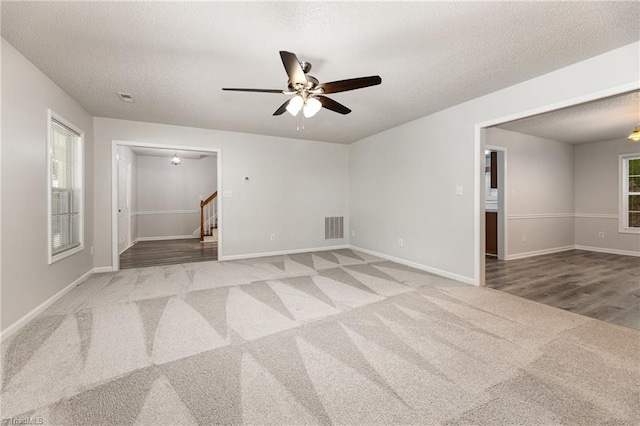 5207 Highland Oak Ct, Greensboro, NC 27410 - carpeted spare room with a ceiling fan, stairway, and a textured ceiling