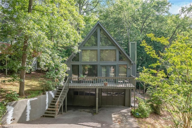 1920 Chateau Rdg, Winston-Salem, NC 27103 - view of front facade with an attached garage, stairway, a chimney, and driveway