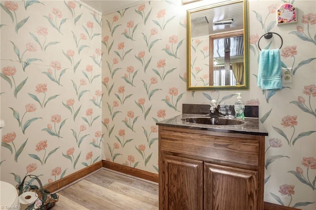 1920 Chateau Rdg, Winston-Salem, NC 27103 - bathroom featuring wallpapered walls, wood finished floors, baseboards, and vanity