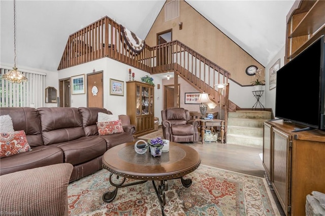 1920 Chateau Rdg, Winston-Salem, NC 27103 - living room with stairway, high vaulted ceiling, wood finished floors, and a chandelier