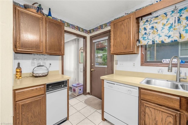 1920 Chateau Rdg, Winston-Salem, NC 27103 - kitchen featuring white dishwasher, a sink, tasteful backsplash, and light countertops