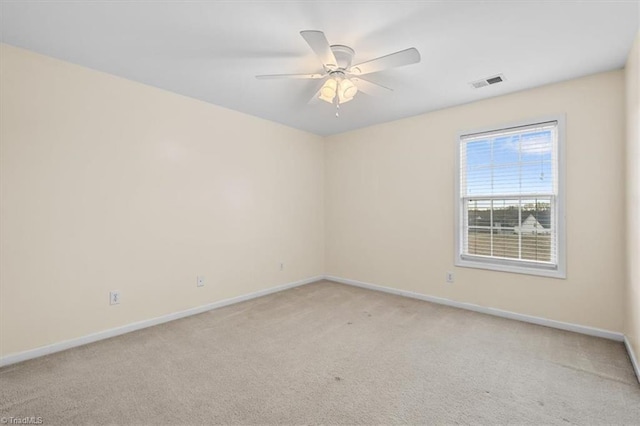 empty room with light carpet, baseboards, visible vents, and ceiling fan