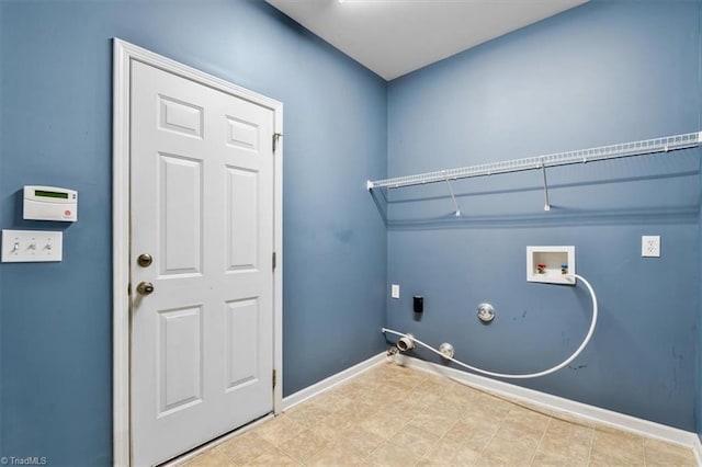 washroom with hookup for a gas dryer, baseboards, laundry area, and washer hookup