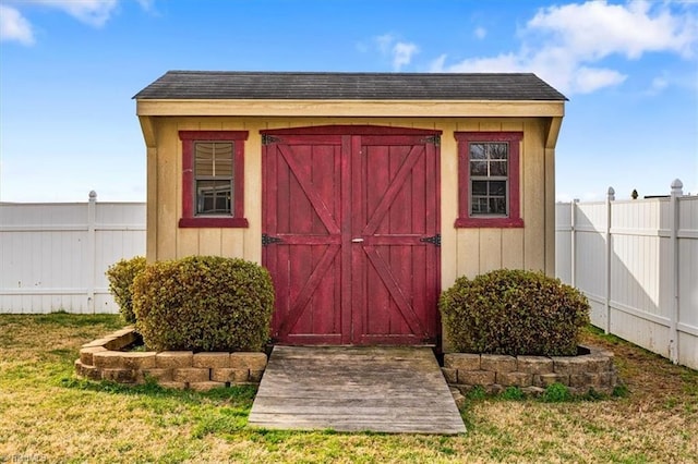 view of shed featuring fence