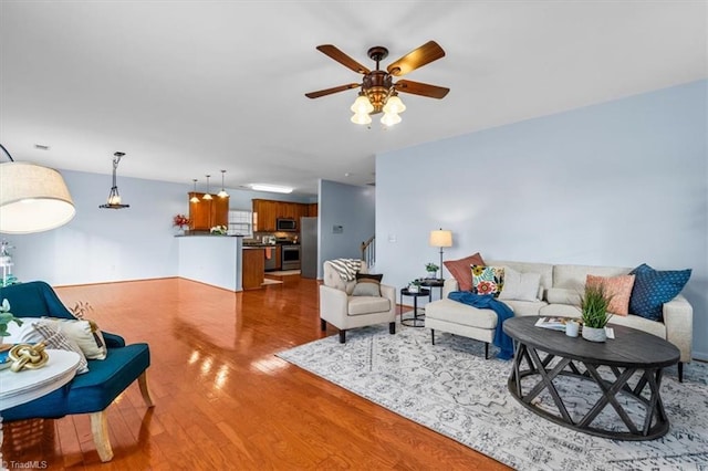 living room featuring ceiling fan and wood finished floors