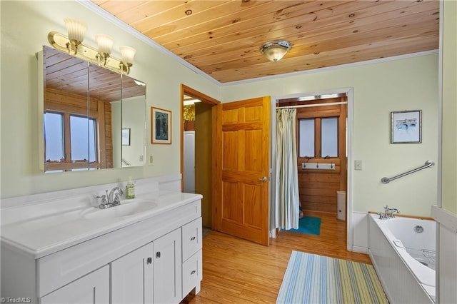 bathroom with a tub to relax in, wood ceiling, crown molding, vanity, and hardwood / wood-style flooring