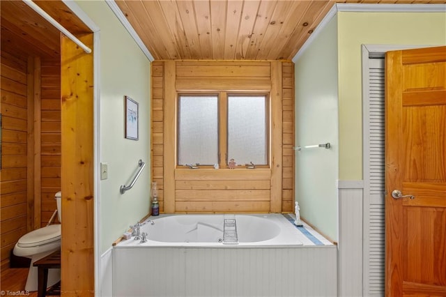 bathroom featuring wood walls, a washtub, wooden ceiling, and toilet